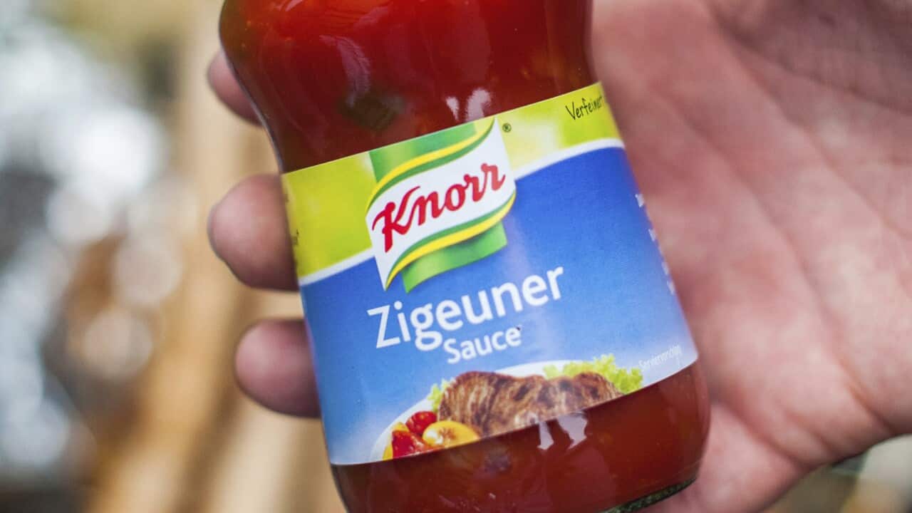 In this May 6, 2014 photo, a man holds a bottle of "gypsy sauce" from the manufacturer Knorr in his hand in Berlin