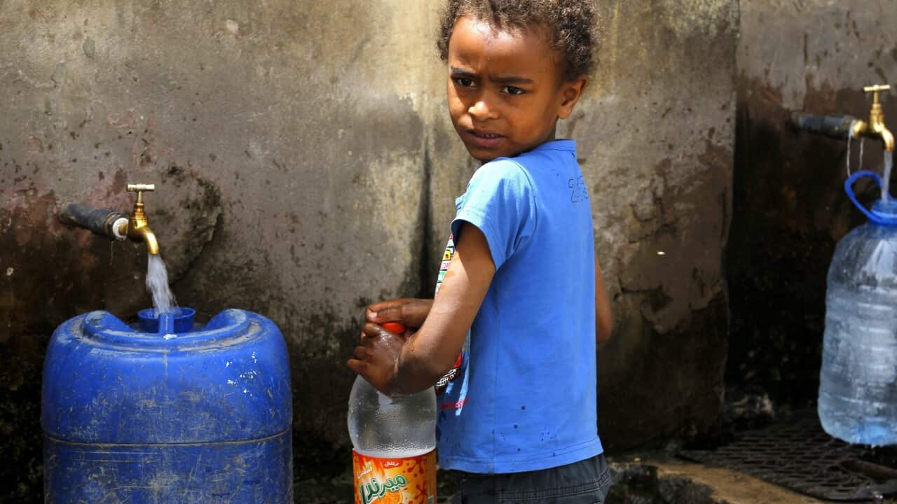A Yemeni child stands beside jerry cans full with water from a philanthropist-provided water tap in Sanaa, Yemen, 07 April 2015.