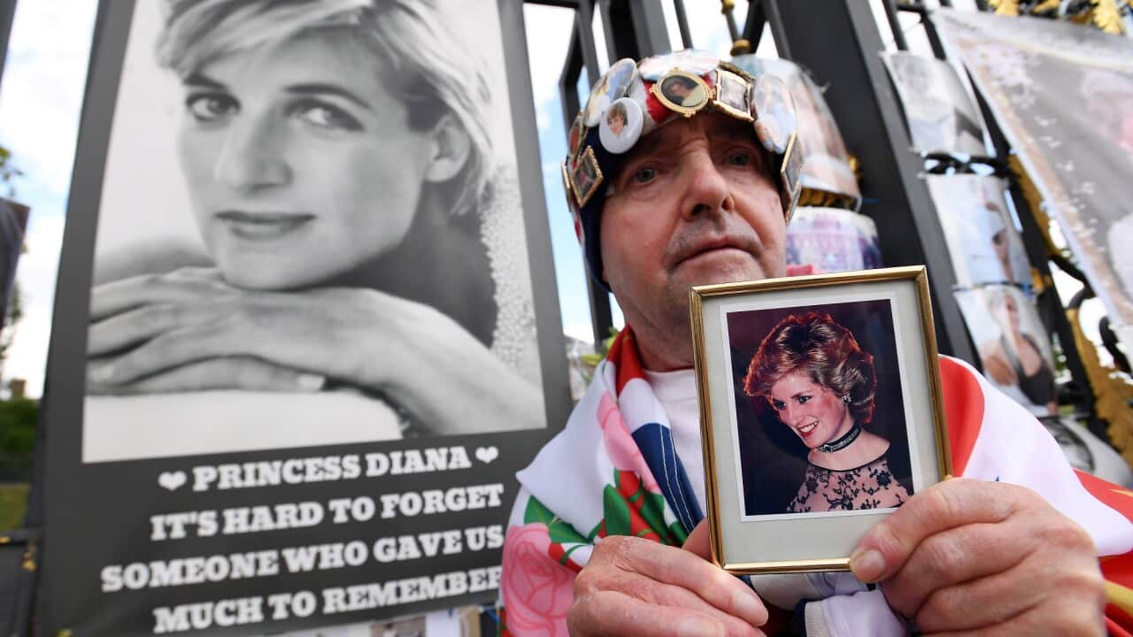 Royal well-wisher John Loughrey holds a photograph of Princess Diana outside Kensington Palace, the former home of Princess Diana in London on 31 August 2022.