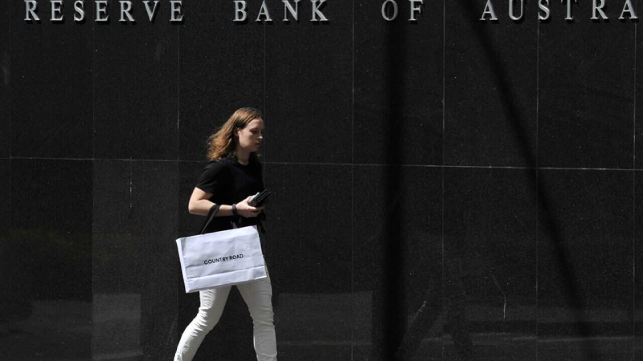 A pedestrian walks past the Reserve Bank of Australia