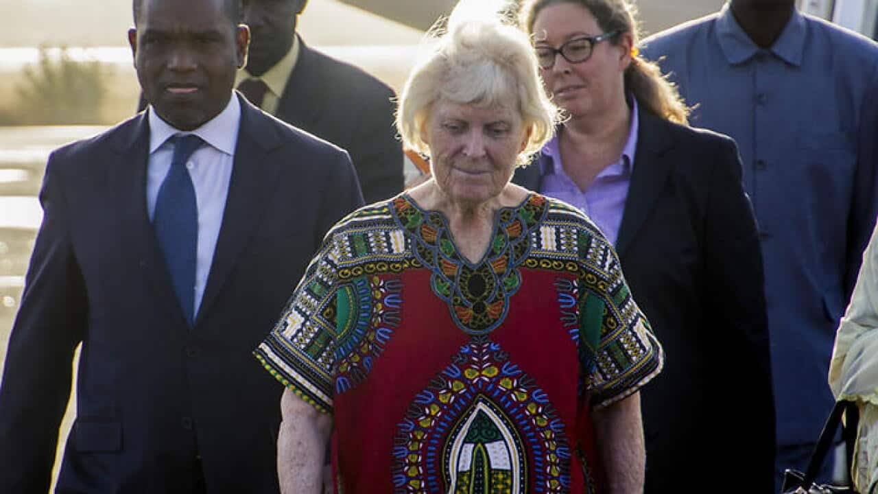 Australian Jocelyn Elliott (C) has arrived back in Burkina Faso after being released by militants. (AAP)