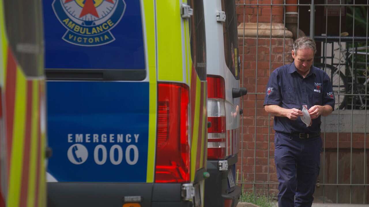 A paramedic by an ambulance in Victoria.