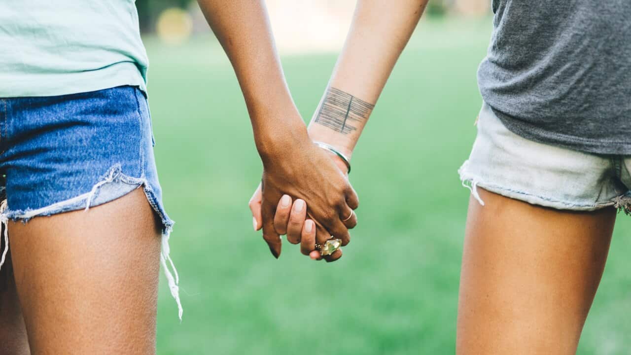 lesbian couple holding hands.