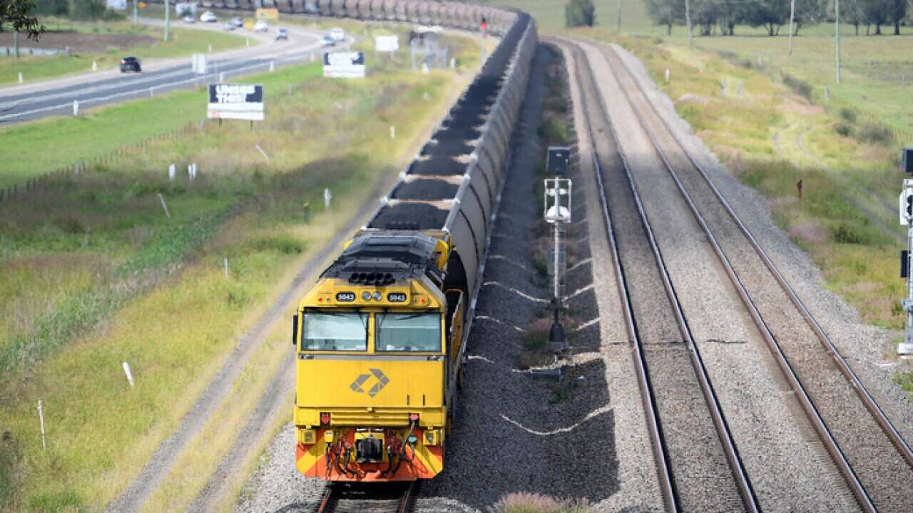 A loaded coal train passes through the outskirts of Singleton, in the NSW Hunter Valley.