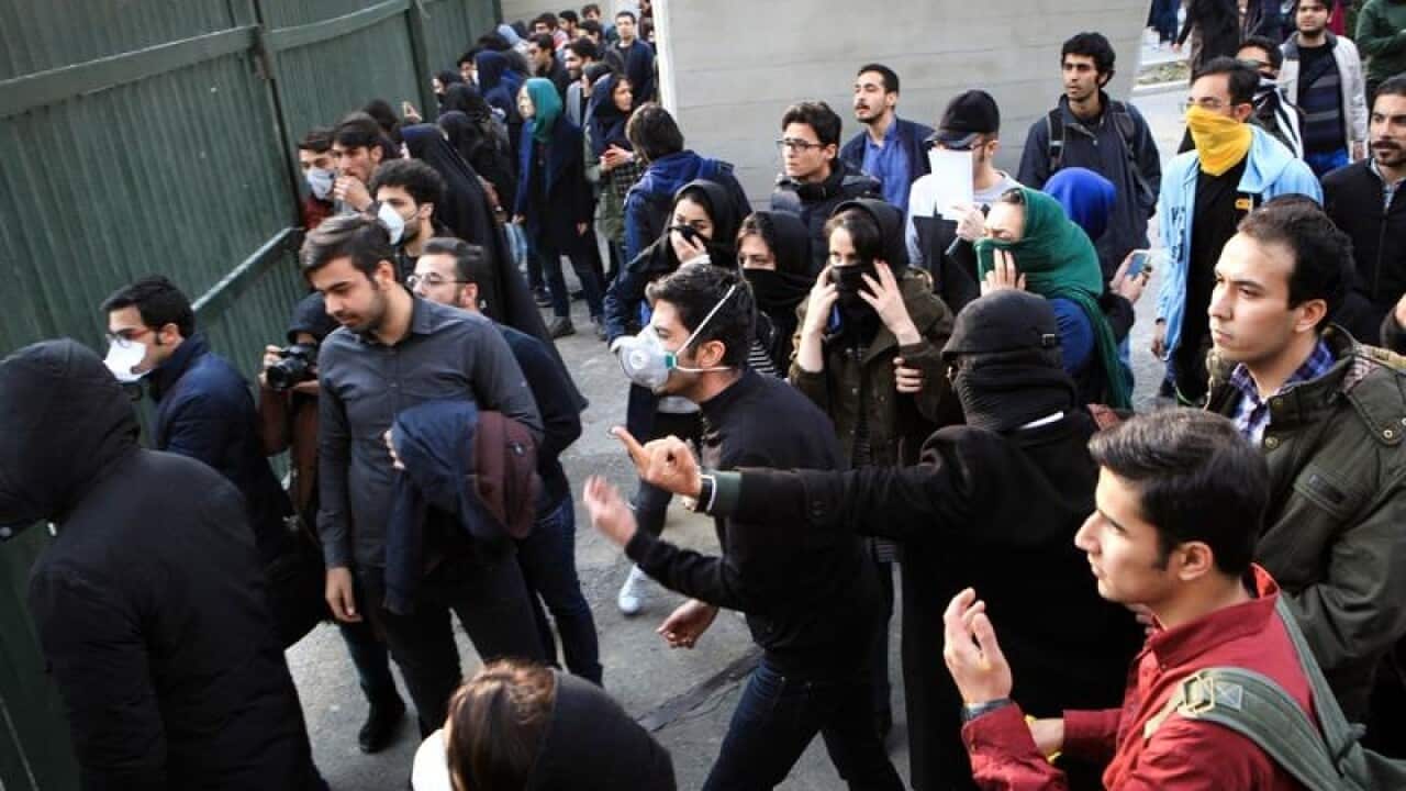Iranian students clash with riot police during protests.