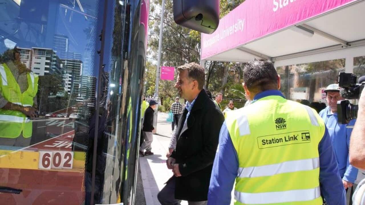 Transport Minister Andrew Constance boards a new station link bus.