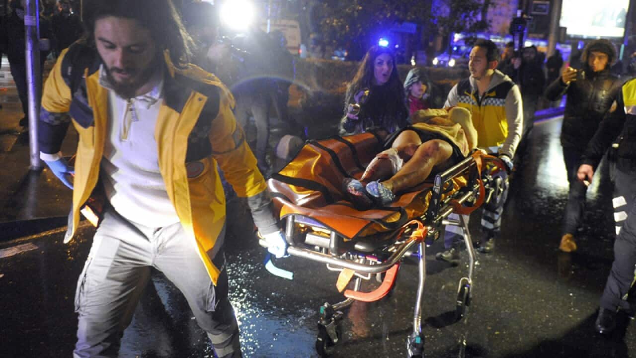 Medics carry a wounded person at the scene of a shooting in Istanbul