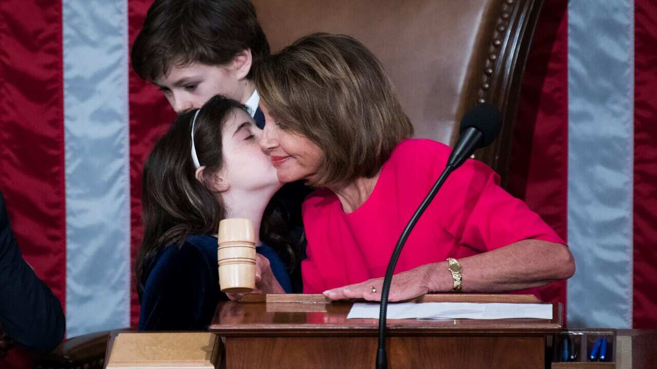 Speaker of the House Nancy Pelosi gets a kiss from her granddaughter, Bella Kaufman.