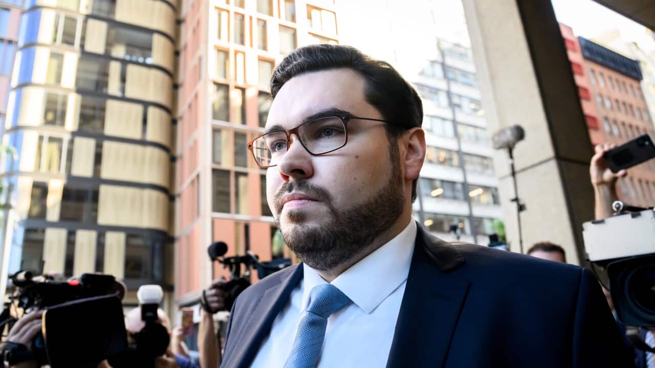 Bruce Lehrmann walks past video cameras outside court.