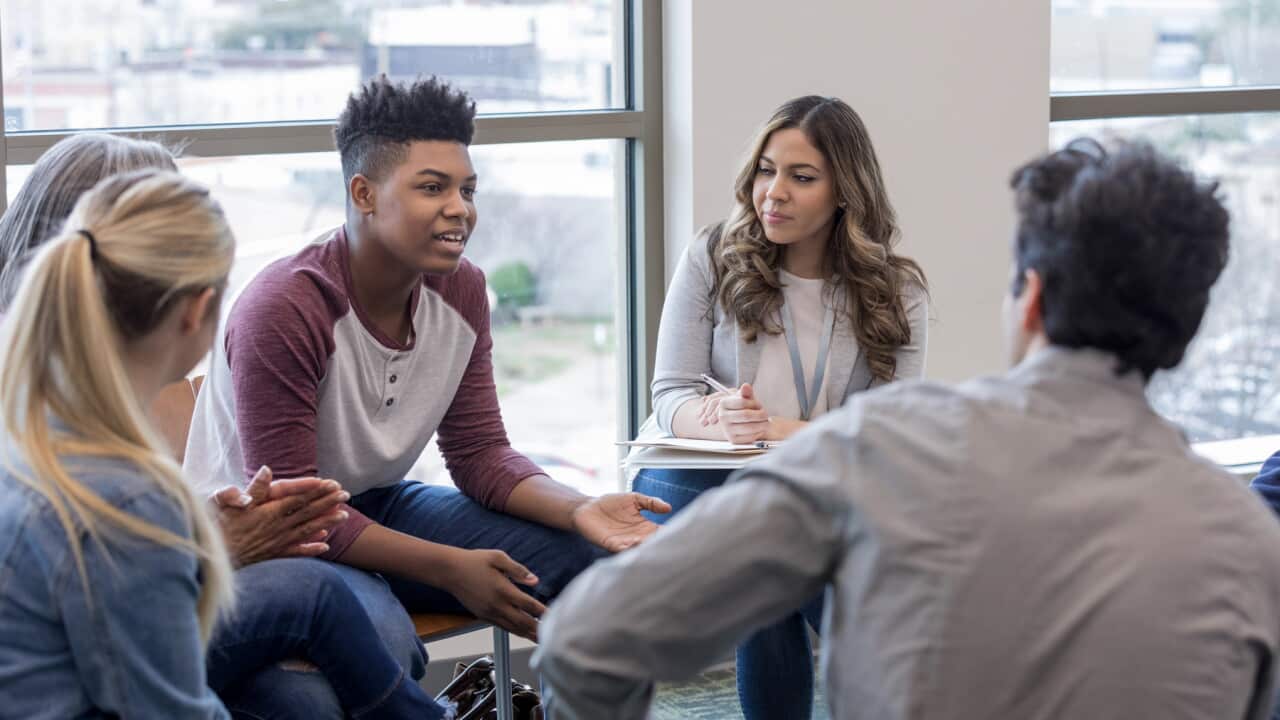 In therapy, teen boy shares life experiences with group