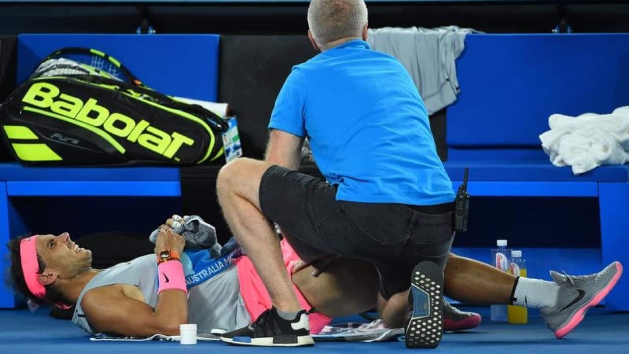 Rafael Nadal is treated court-side at the Australian open.