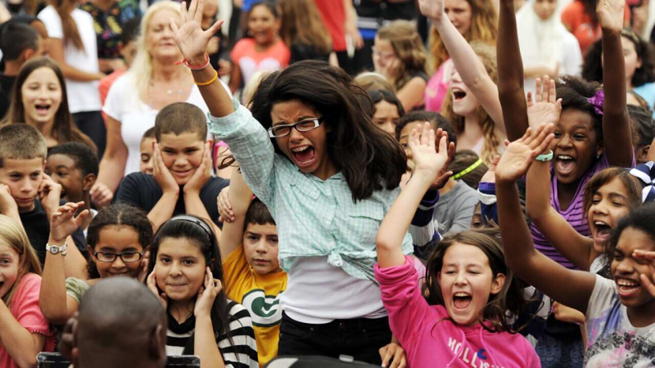 One Direction fans scream.