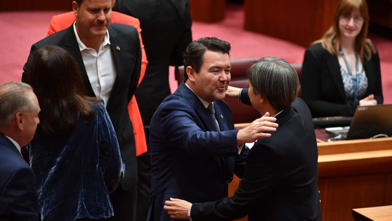 Liberal Senator Dean Smith hugs Shadow Minister for Foreign Affairs Penny Wong after speaking on the Same Sex Marriage Bill debate in the Senate chamber at Parliament House in Canberra, Thursday, November 16, 2017. (AAP Image/Mick Tsikas) NO ARCHIVING