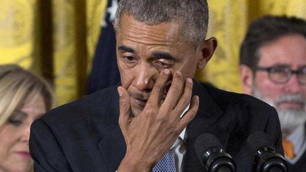 President Barack Obama wipes tears from his eyes as he speaks in the East Room of the White House in Washington about steps his administration is taking to reduce gun violence. Also on stage are stakeholders, and individuals whose lives have been impacte