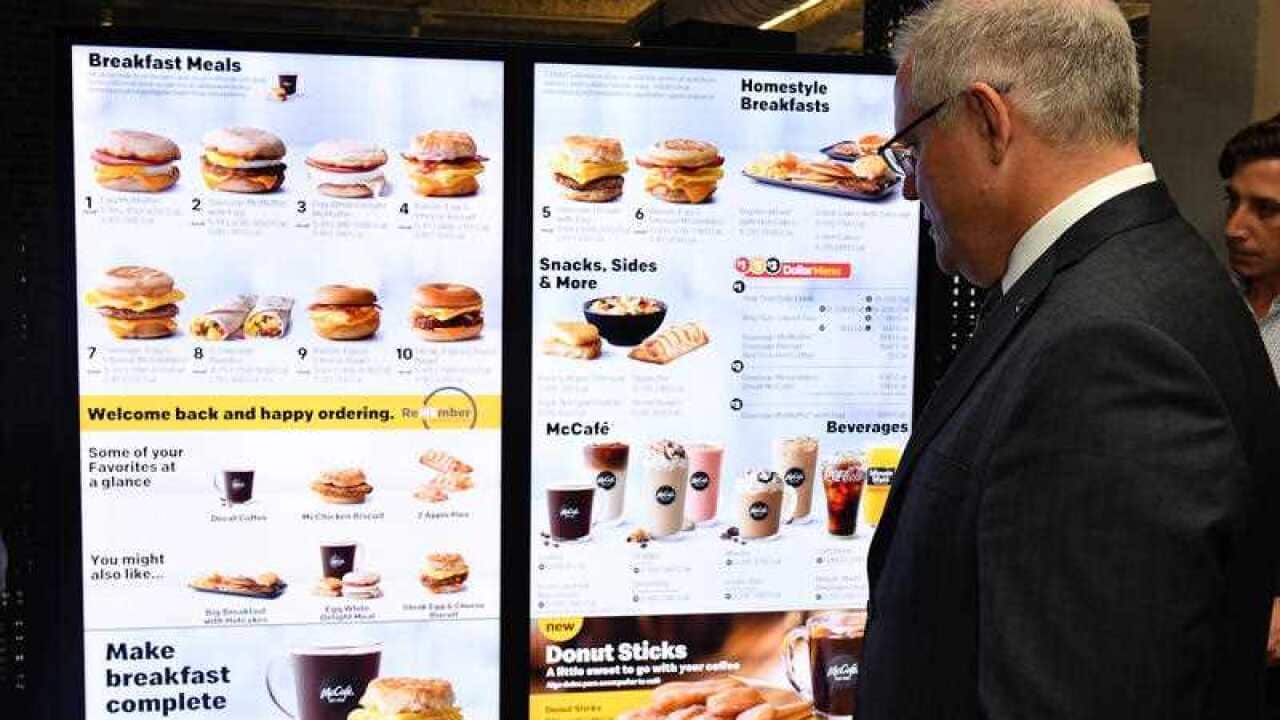 Scott Morrison looks at McDonald's electronic menu board