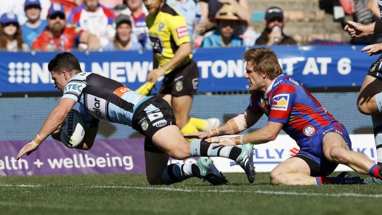 Chad Townsend of the Sharks scores a try.