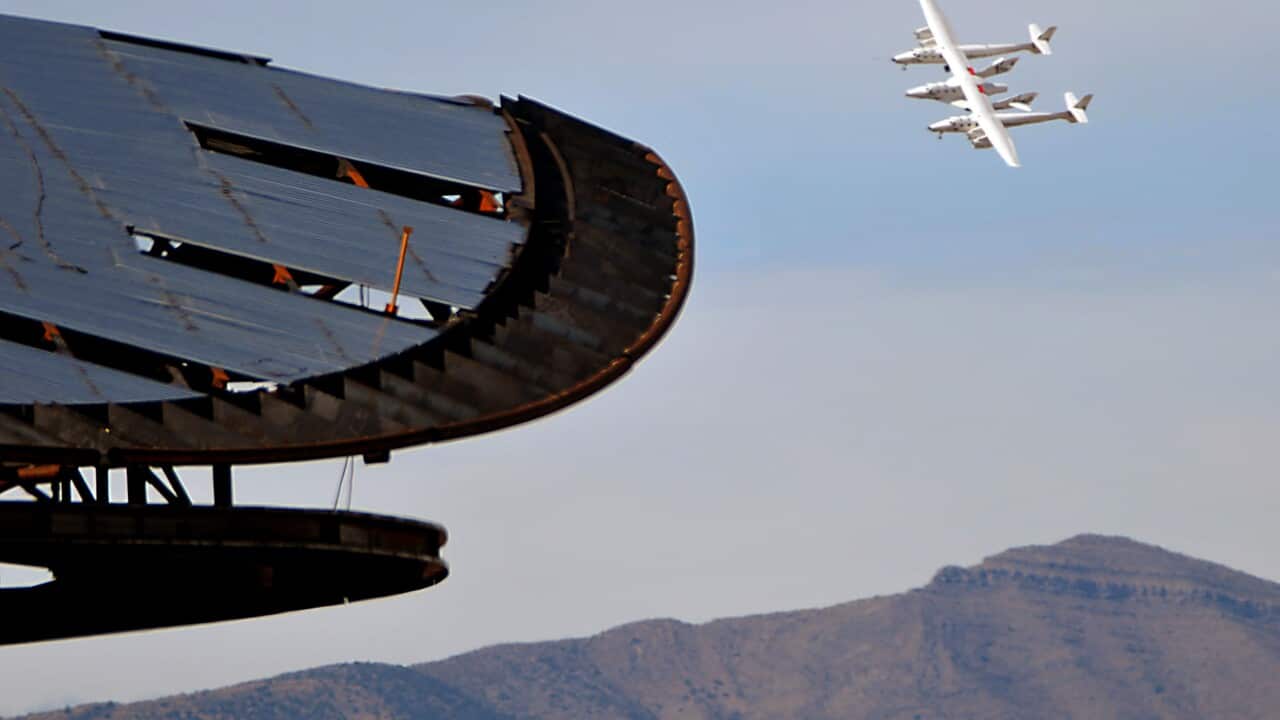 Virgin Galactic's White Knight Two jet-powered carrier aircraft flies over Spaceport America