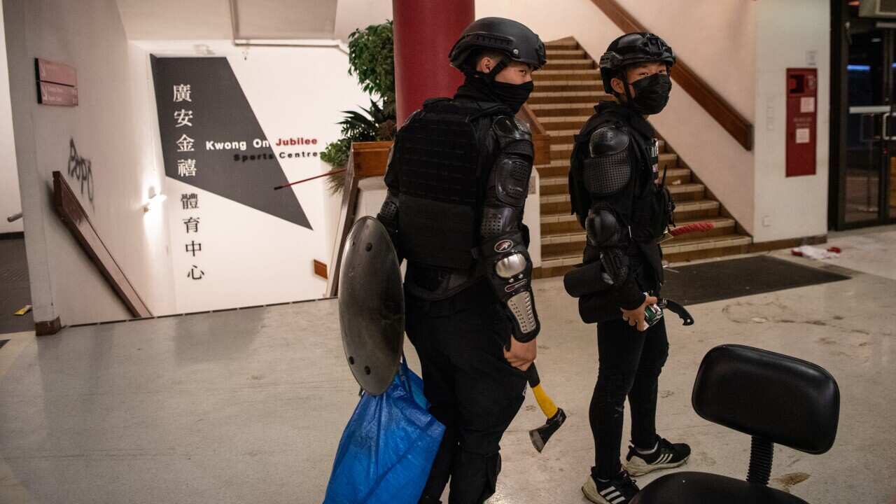 Anti-government protesters walk around campus at Hong Kong Polytechnic University.