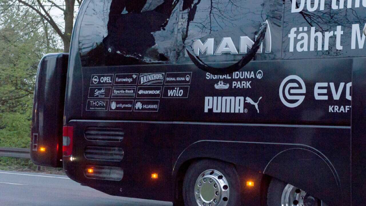 The Borussia Dortmund team bus is seen damaged from an explosion