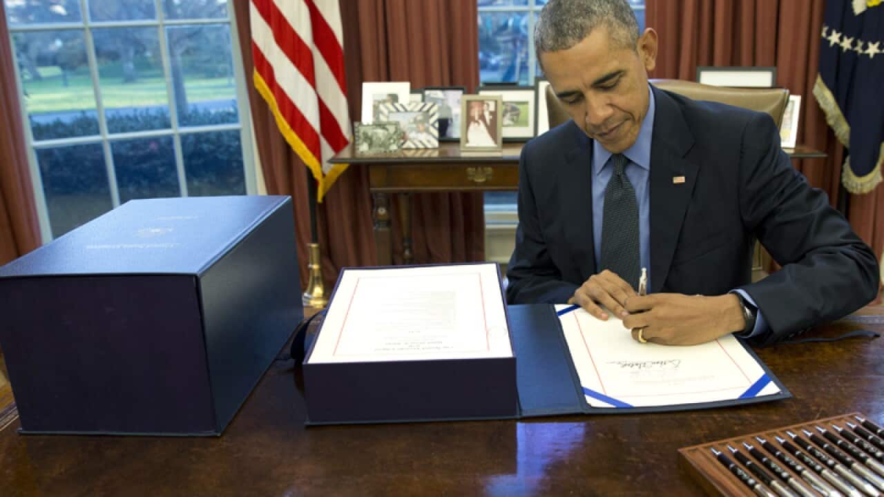 US President Barack Obama signs the budget bill