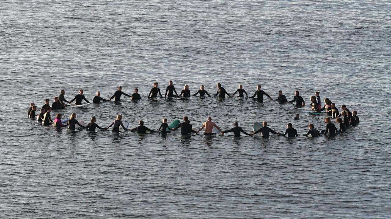 Surfers take part in a paddle-out part as part of a protest at Bells Beach, south of Melbourne.