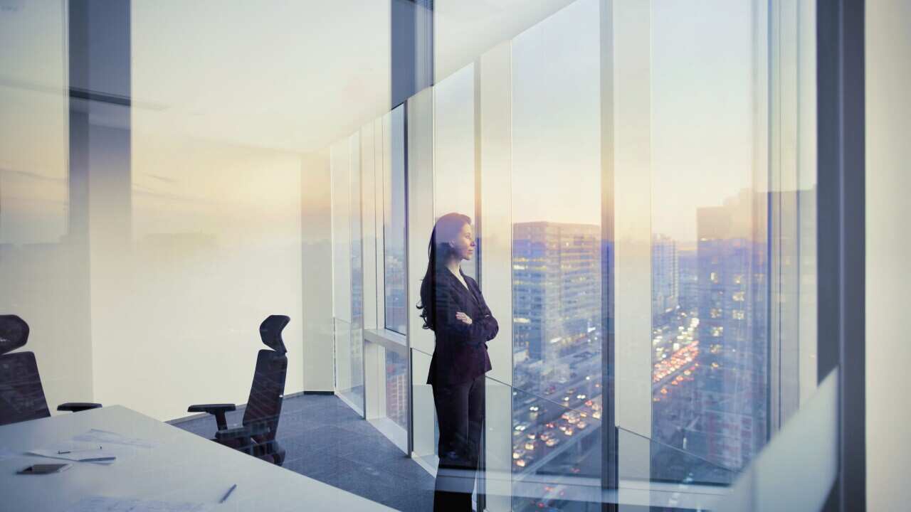 Businesswoman looking out window in meeting room