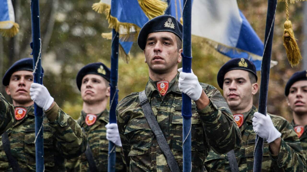 Soldiers seen holding military flags during the parade.