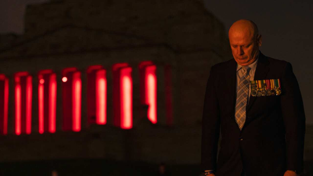 People pay their respects during the Anzac Day Dawn Service at the Shrine of Remembrance in Melbourne, Saturday, April 25, 2020