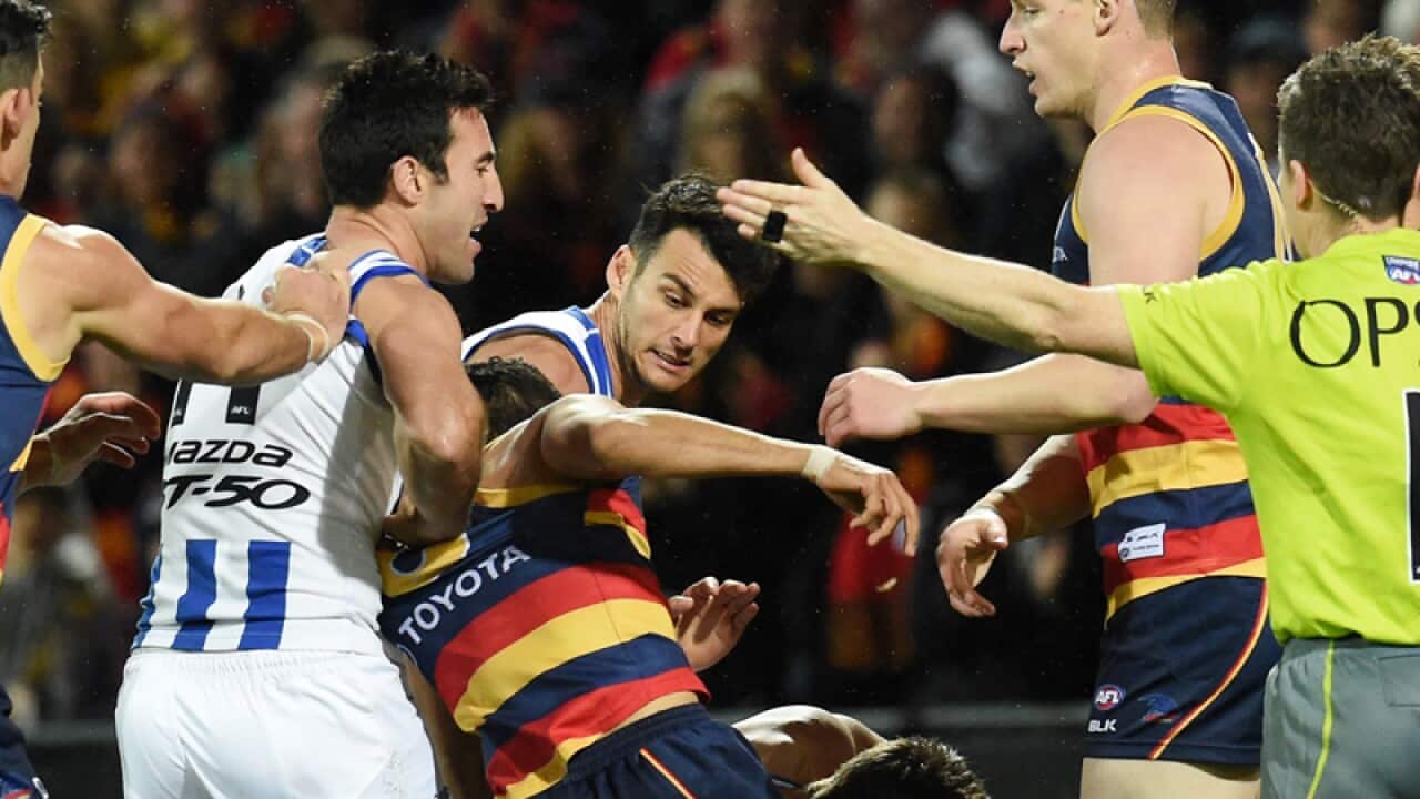 A fight breaks out after Charlie Cameron of the Crows