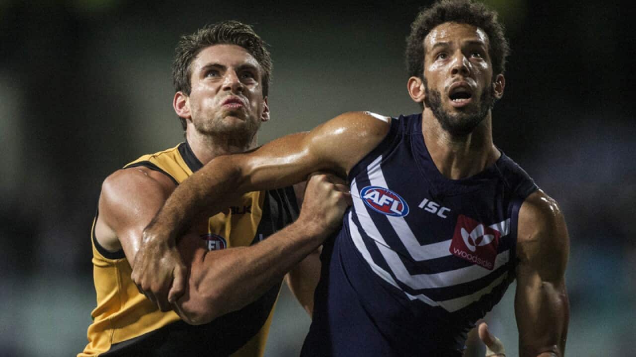 Shaun Hampson of Richmond and Zac Clarke of the Fremantle Dockers