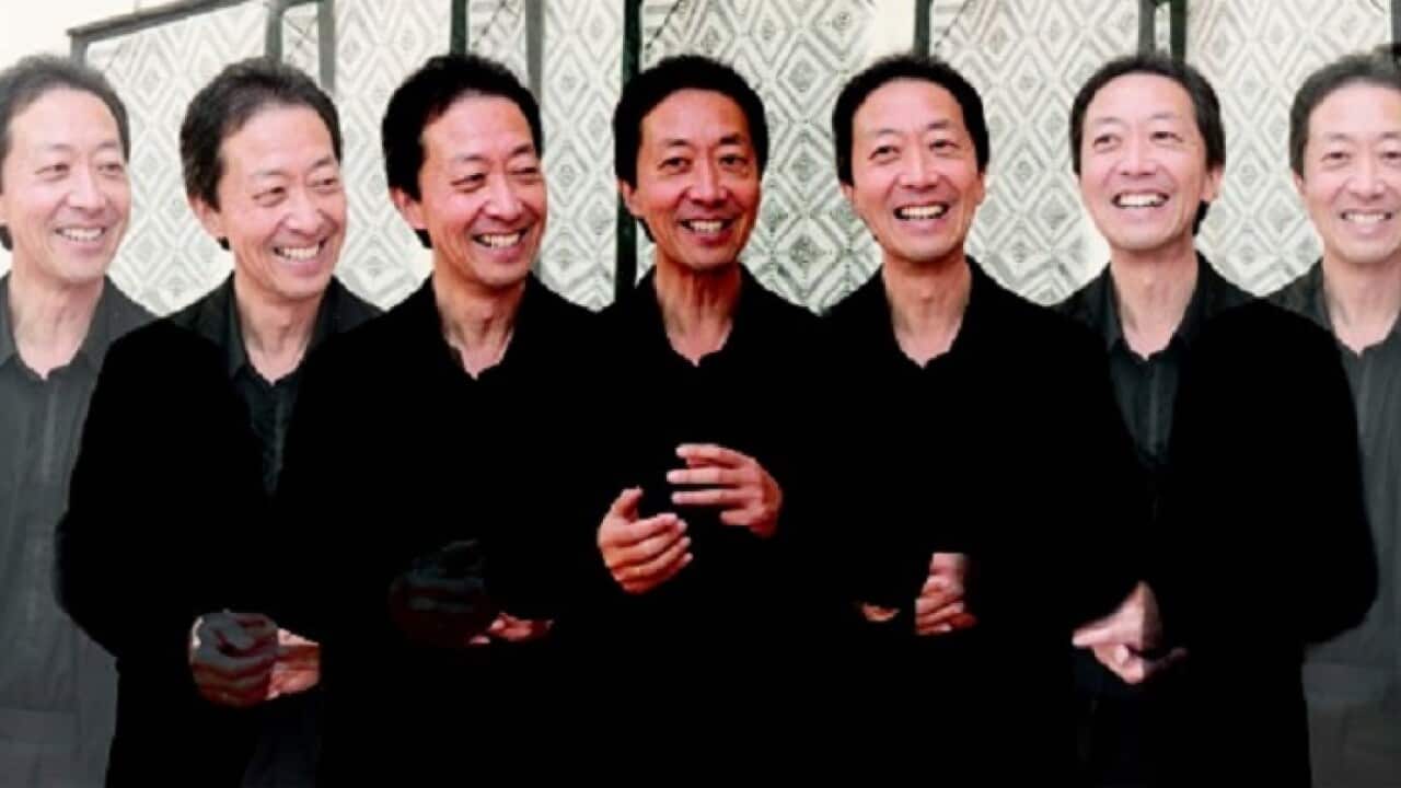 Simon Chan in front of artwork by Susan Marawarr