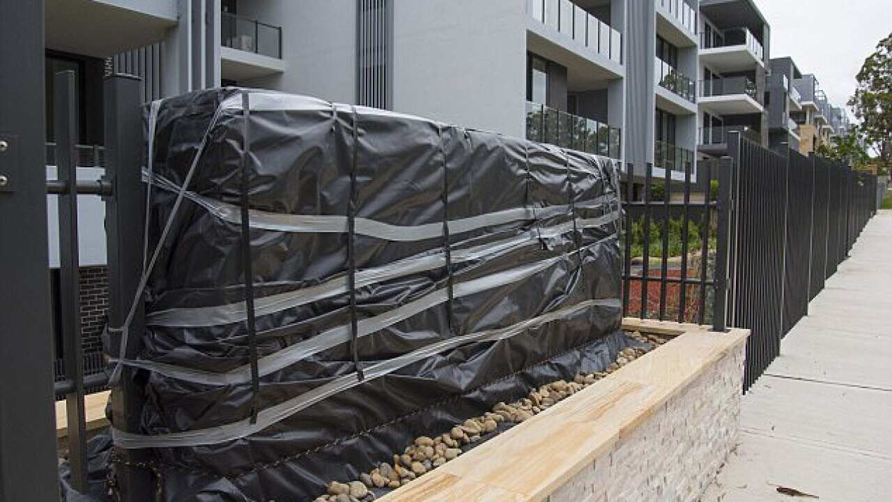 A sign written completely in Mandarin outside a $35 million apartment complex has been covered up after it sparked fury over the weekend