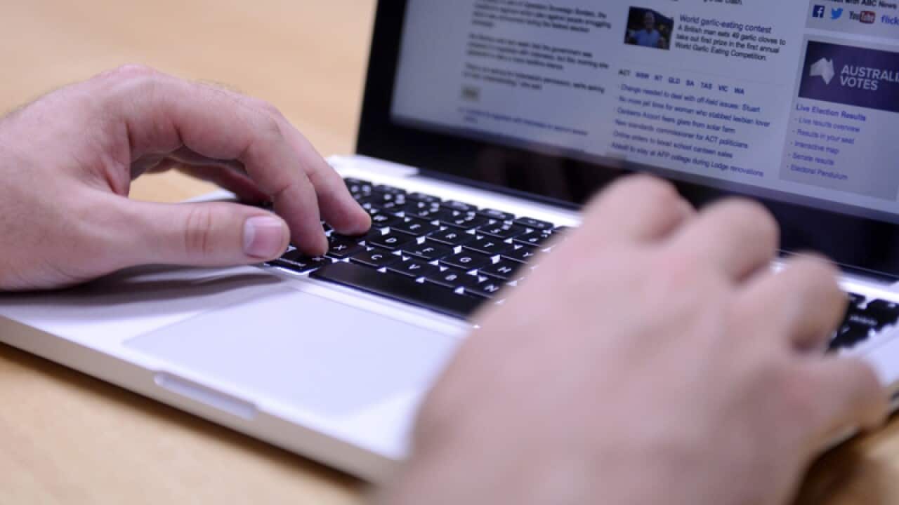 A man uses a laptop computer