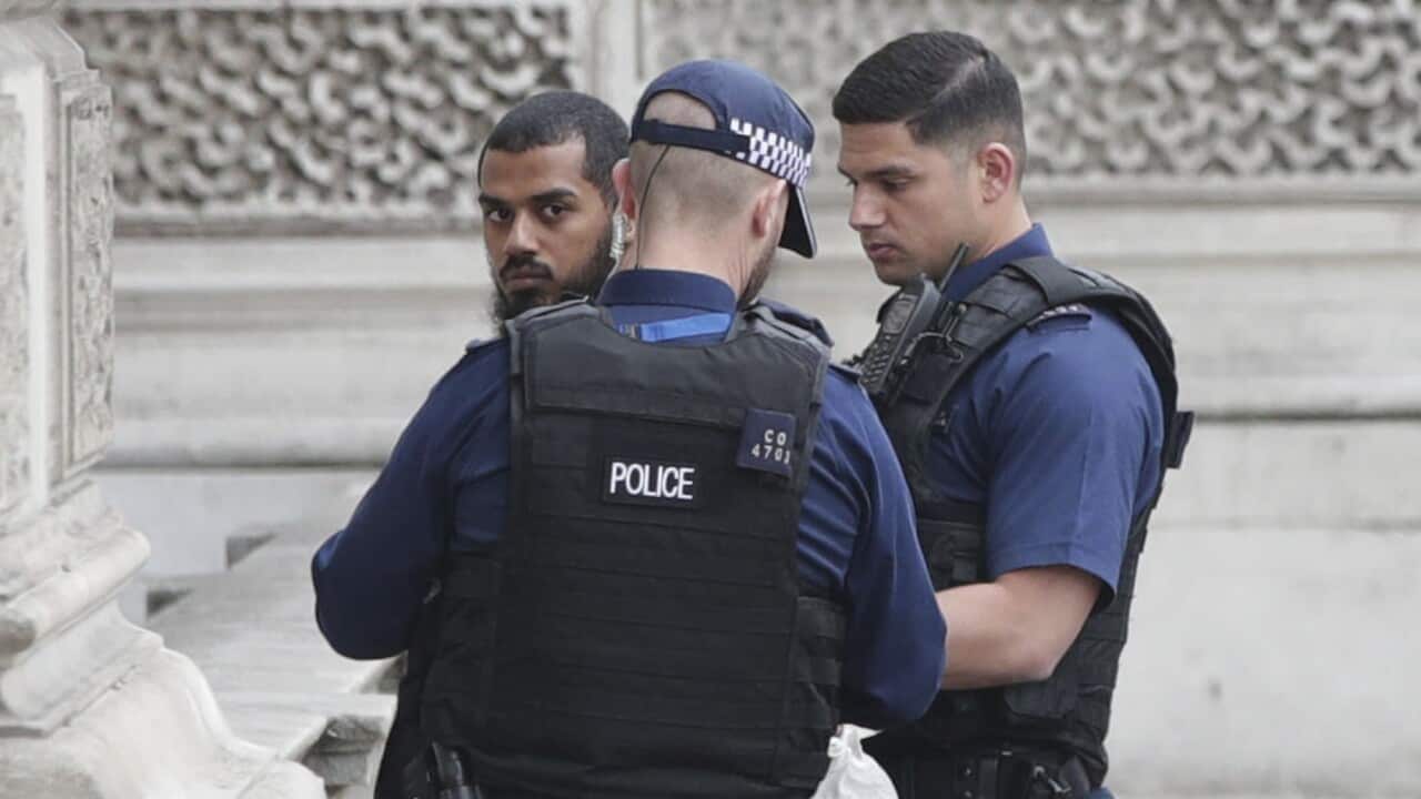 Armed police talk to an unidentified man at the scene following an incident at Whitehall in London, Thursday April 27, 2017. London police arrested a man for possession of weapons Thursday near Britain’s Houses of Parliament. (Yui Mok/PA via AP)