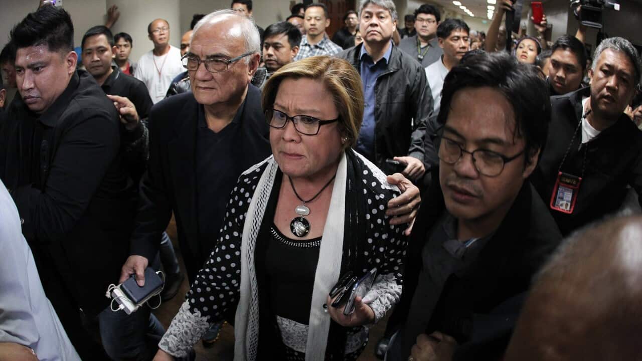 A handout photo made available by the Philippine Senate-Public Relations and Information Bureau (PRIB) shows Filipino Senator Leila De Lima (C) reacting.