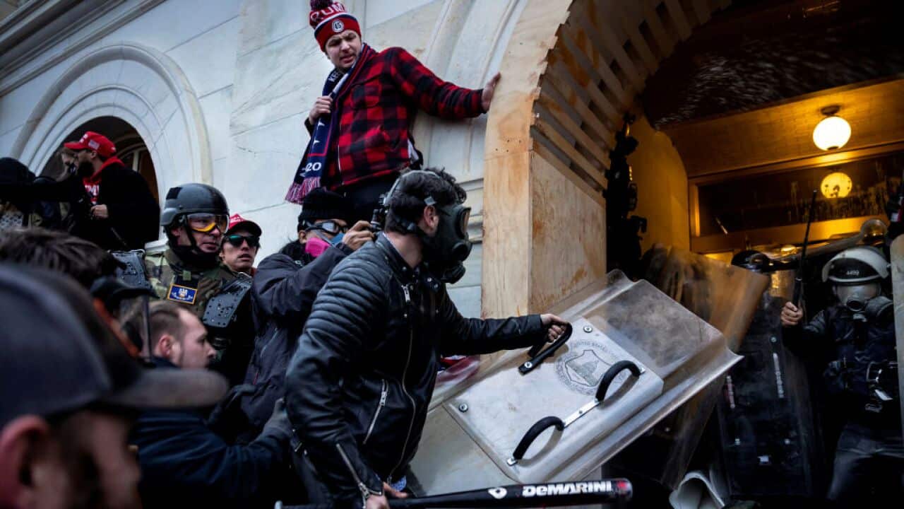 Trump supporters clash with police and security forces as people try to storm the US Capitol in Washington DC on 6 January, 2021.