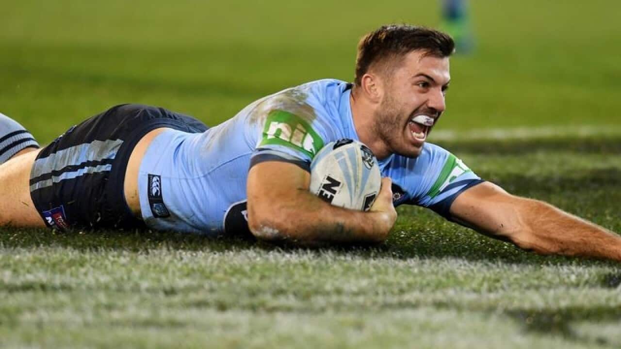 James Tedesco of the Blues scores a try during Game 1.