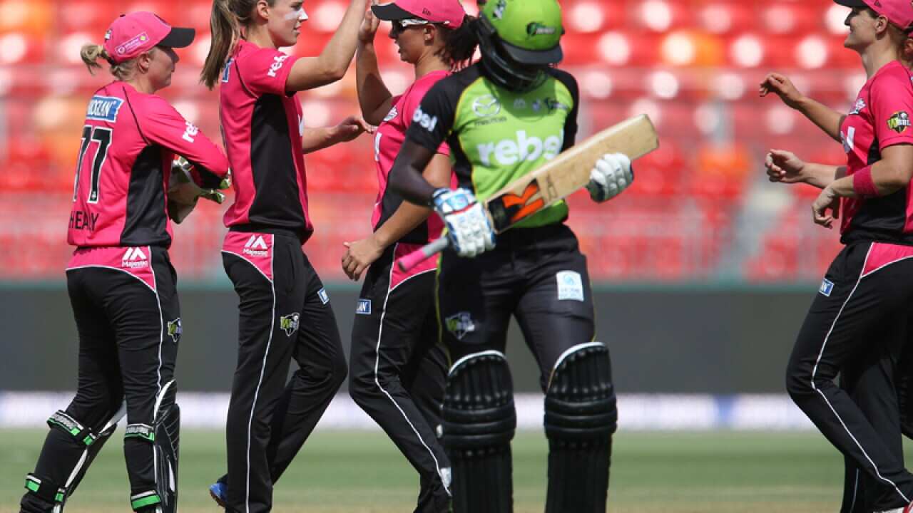 Ellyse Perry (2L) celebrates after claiming Thunder's Stafanie Taylor