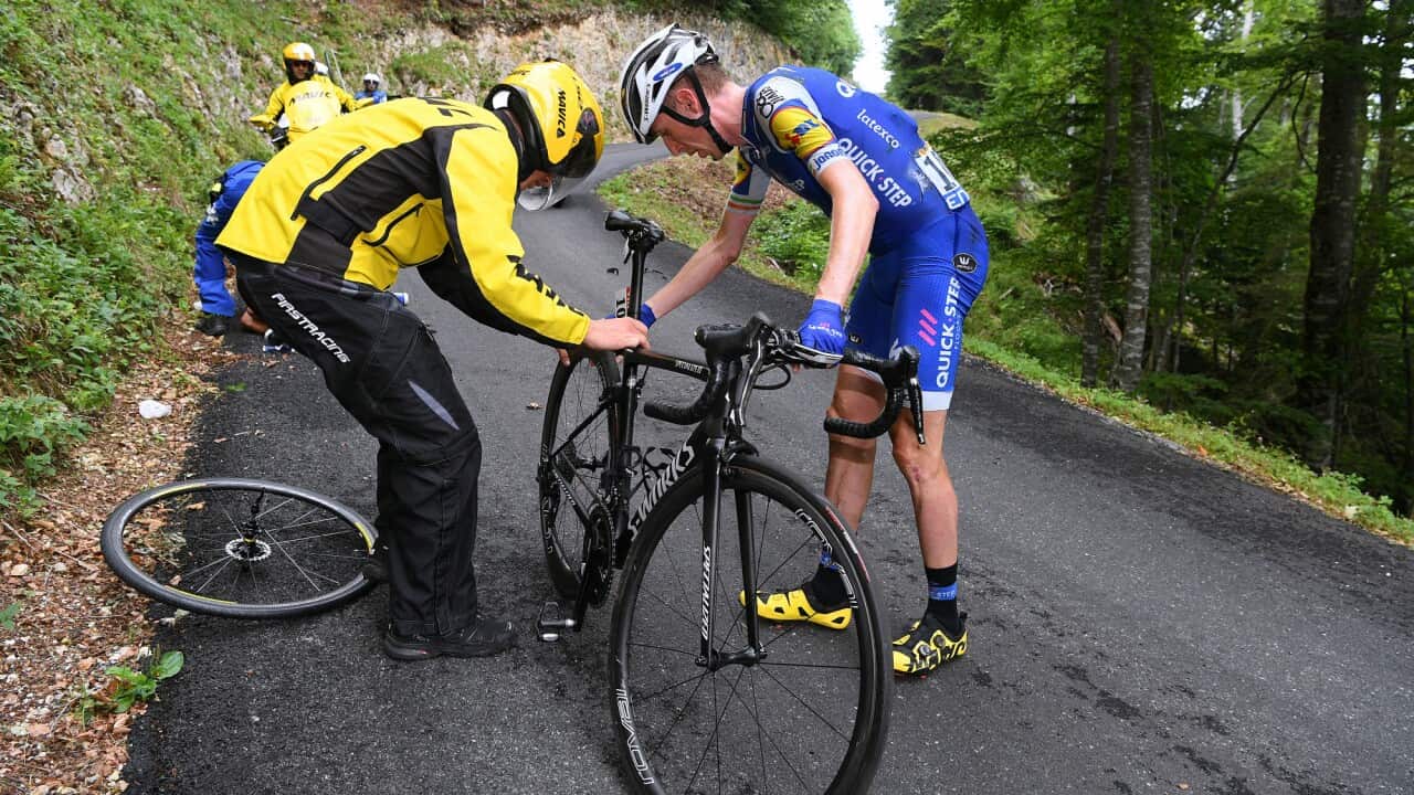 "I guess the organisers got what they wanted"... Daniel Martin receives a new rear wheel after crashing with Richie Porte on the descent of the Mont du Chat.