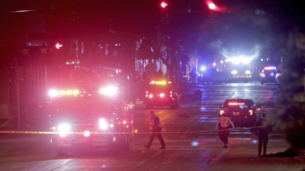 Police investigate at the scene of the Waukesha incident