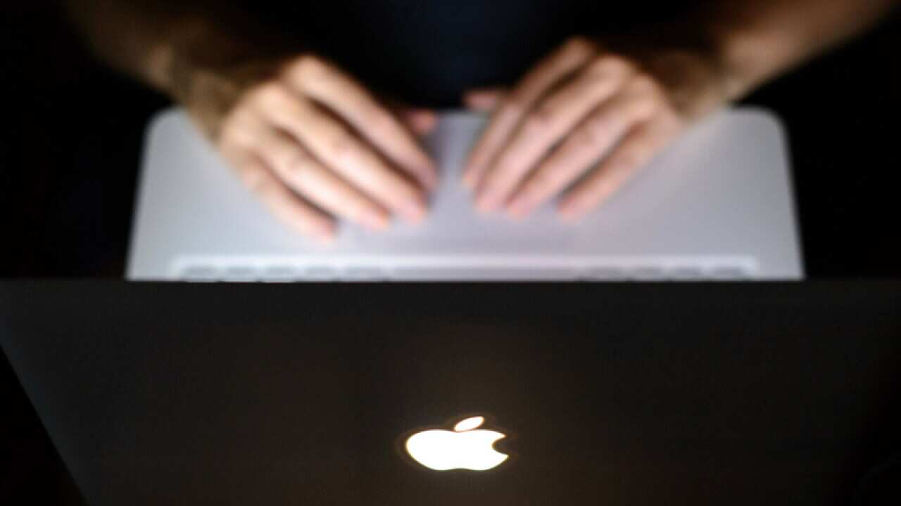 A person uses a Apple laptop