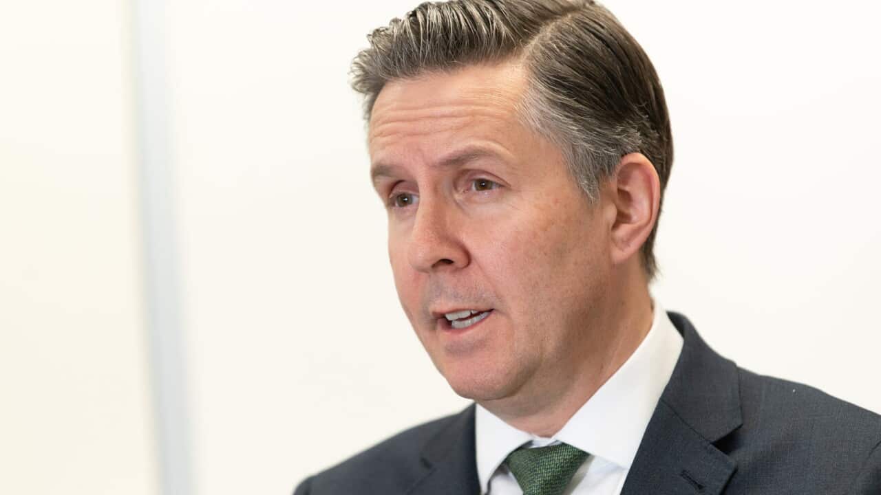 A man in a suit speaking.