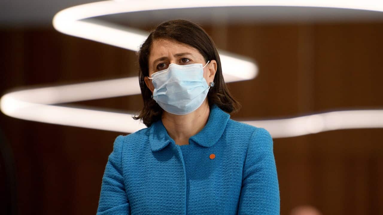 NSW Premier Gladys Berejiklian watches on during a press conference