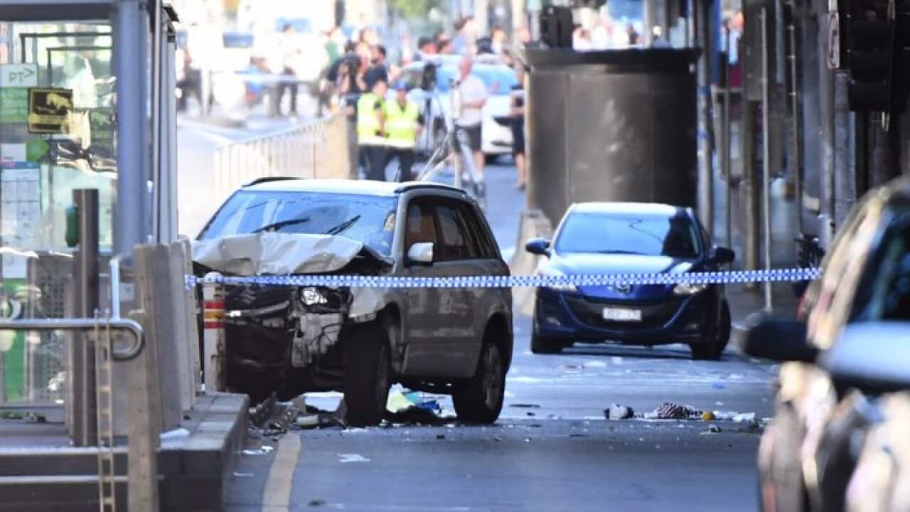 A damaged vehicle is seen at the scene of an incident on Flinders Street, in Melbourne, Thursday, December 21, 2017. A vehicle has ploughed into pedestrians in central Melbourne. (AAP Image/Joe Castro)