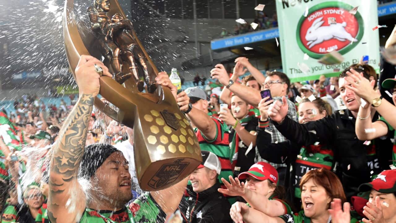 Rabbitohs' Issac Luke carries the Proven-Summons trophy