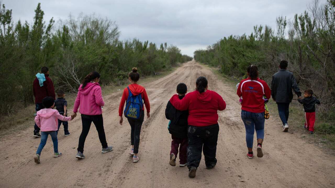 Migrants cross the border to the US