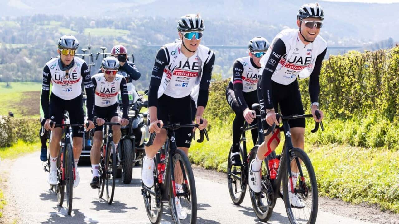 Tadej Pogacar rides alongside his UAE Team Emirates teammates