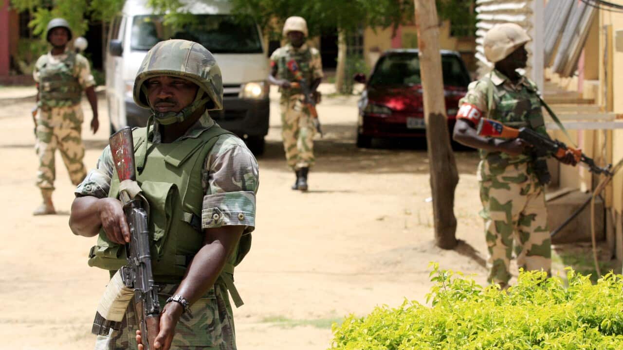 (File Image) Nigerian soldiers on guard in Maiduguri in June 2013.