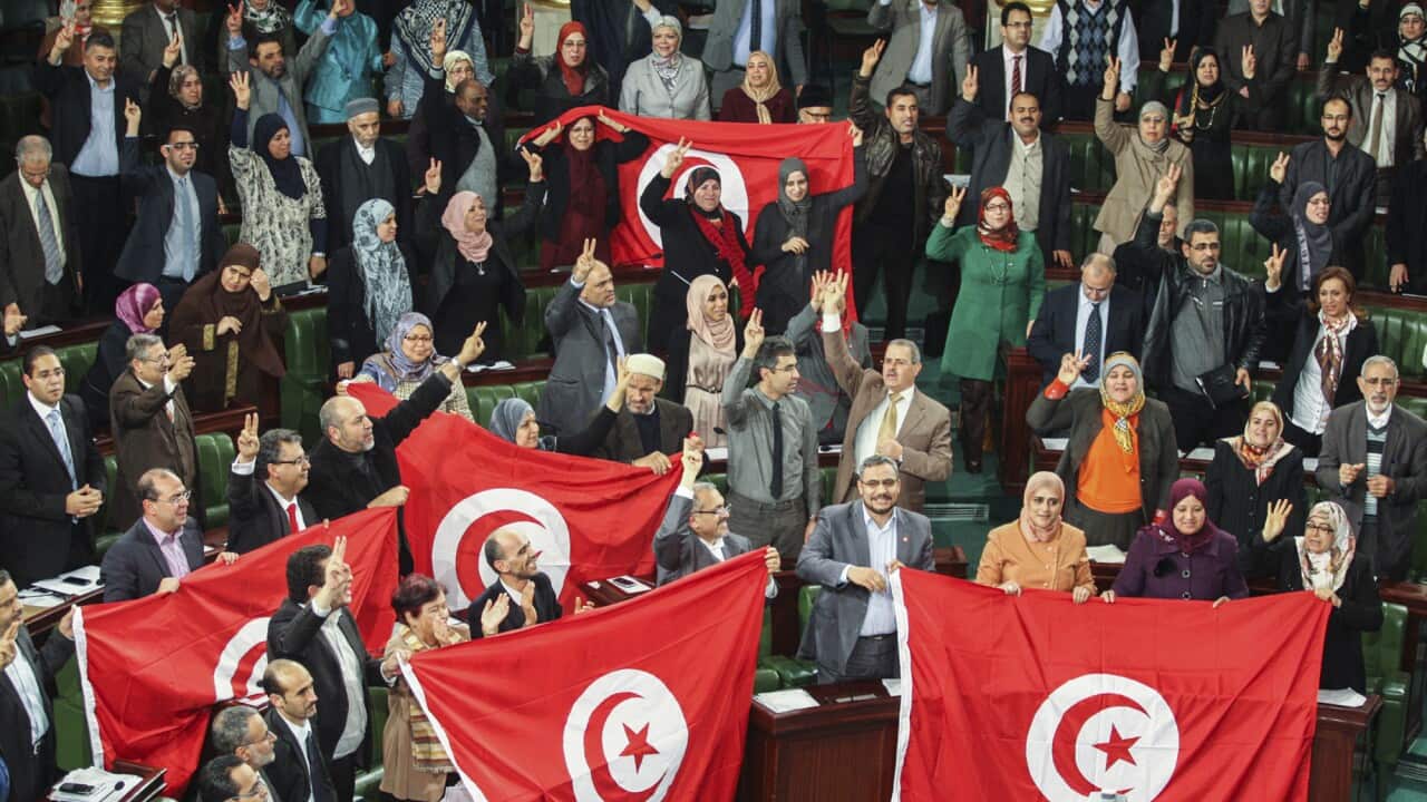 Members of the Tunisian National Constituent Assembly celebrate the adoption of the new constitution in Tunis, Tunisia on Jan. 26, 2014.