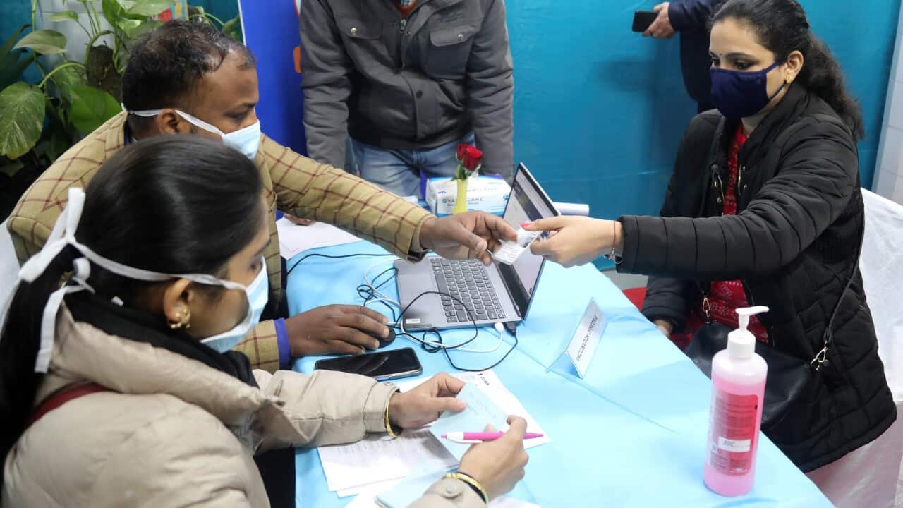 Health official and volunteers interact during a nationwide dry run of the Covid-19 vaccine rollout in Delhi.